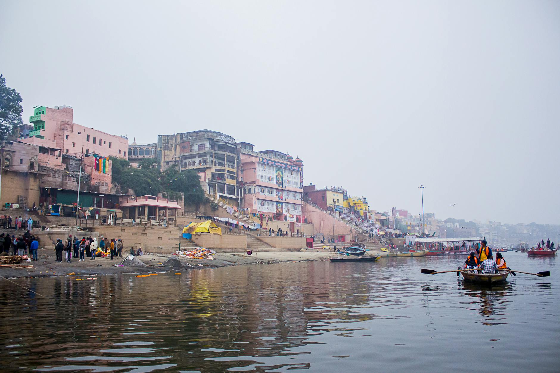 Varanasi Dashashwamedh Ghat at sunrise with boats and pilgrims